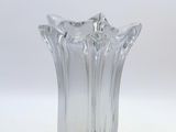 a clear glass vase sitting on top of a white table