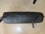 a black bag sitting on the floor next to a black chair