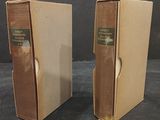 pair of vintage books in cardboard boxes on a black surface