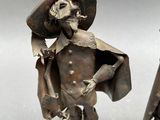 pair of silver figurines of a man and a woman dressed in medieval clothing