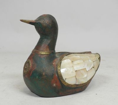 an image of a duck with a shell in its beak