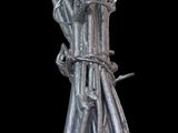 a bunch of silver sticks tied to a black background