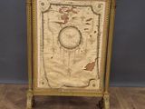 a gold frame with a map on it sitting on a wooden floor