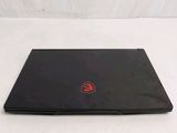 a black laptop with a red logo on the screen