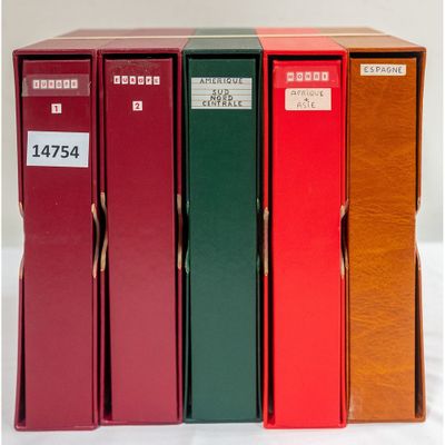 several red and green books are stacked on top of each other