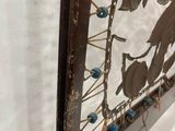 a mirror with a bird on it hanging on a wall
