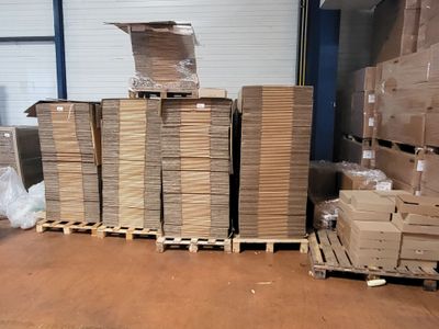 a large pile of boxes sitting on a pallet in a warehouse