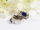 a silver ring with a blue stone in it