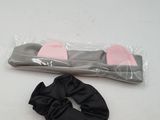 a pair of pink and black scrunes on a white table