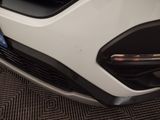 a close up of the front bumper of a white car
