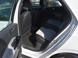 a white car with its door open in a parking lot
