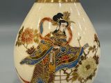 a white vase with a picture of a woman on it