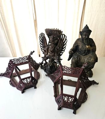 three asian figurines sitting on a white table