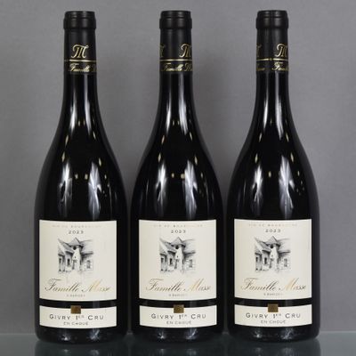 three bottles of wine are lined up on a table