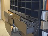 a kitchen that has a lot of shelves and cabinets in it