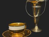 a cup and saucer sitting next to a cup on a saucer