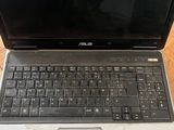 an open laptop computer sitting on top of a wooden table