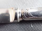 a close up of a silver knife on a table