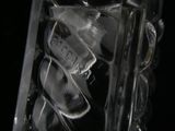 a close up of a glass bottle with ice inside of it