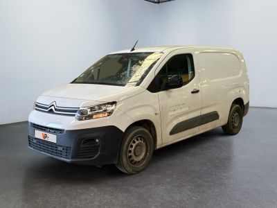 the white van is parked in a large room with a black floor