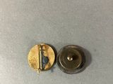 a close up of two metal buttons on a table
