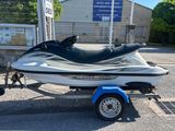 un jet-ski blanc et noir sur une remorque dans un parking