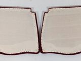 pair of red and white trays sitting on top of a white table