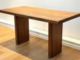a wooden table that is sitting on a hard wood floor