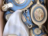 a box full of blue and white tea cups and saucers