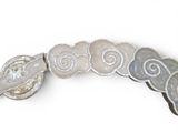 a close up of a silver and white broochle