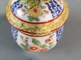 a small decorative box with a lid on a table