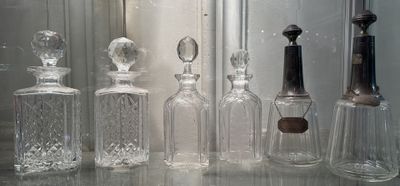 many glass bottles that are lined up on a table