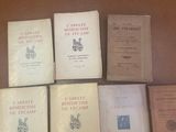 several books are sitting on a table in front of each other