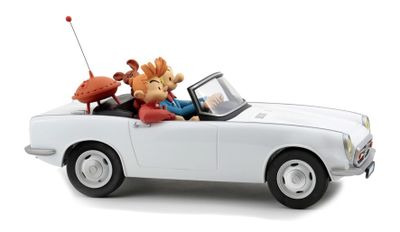 a white toy car with a man and a dog in it