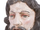 a close up of a statue of jesus with a beard