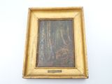 painting of a forest scene in a gold frame on a white wall