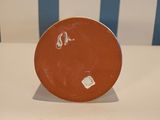 a brown plate sitting on top of a white table
