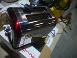 a red toaster sitting on top of a cardboard box