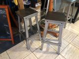 two stools that are sitting on a tiled floor