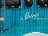 a close up of a blue electric guitar with the words spirit written on it