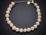a pearl bracelet with a silver clasp on a black background