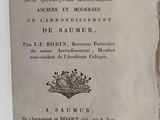 an old book with a crown on it sitting on a table