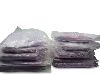 a lot of purple cloths sitting on top of each other