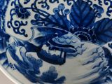 a blue and white plate with a bird on it