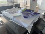 a stack of papers sitting on top of a printer