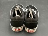 pair of black and white vans slip ons on a gray surface