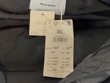 the back of a black jacket with a tag on it