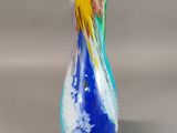 a blue and yellow vase sitting on a table