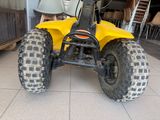 a yellow four wheeler vehicle parked in a garage