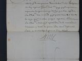 an old document with writing on it sitting on top of a table